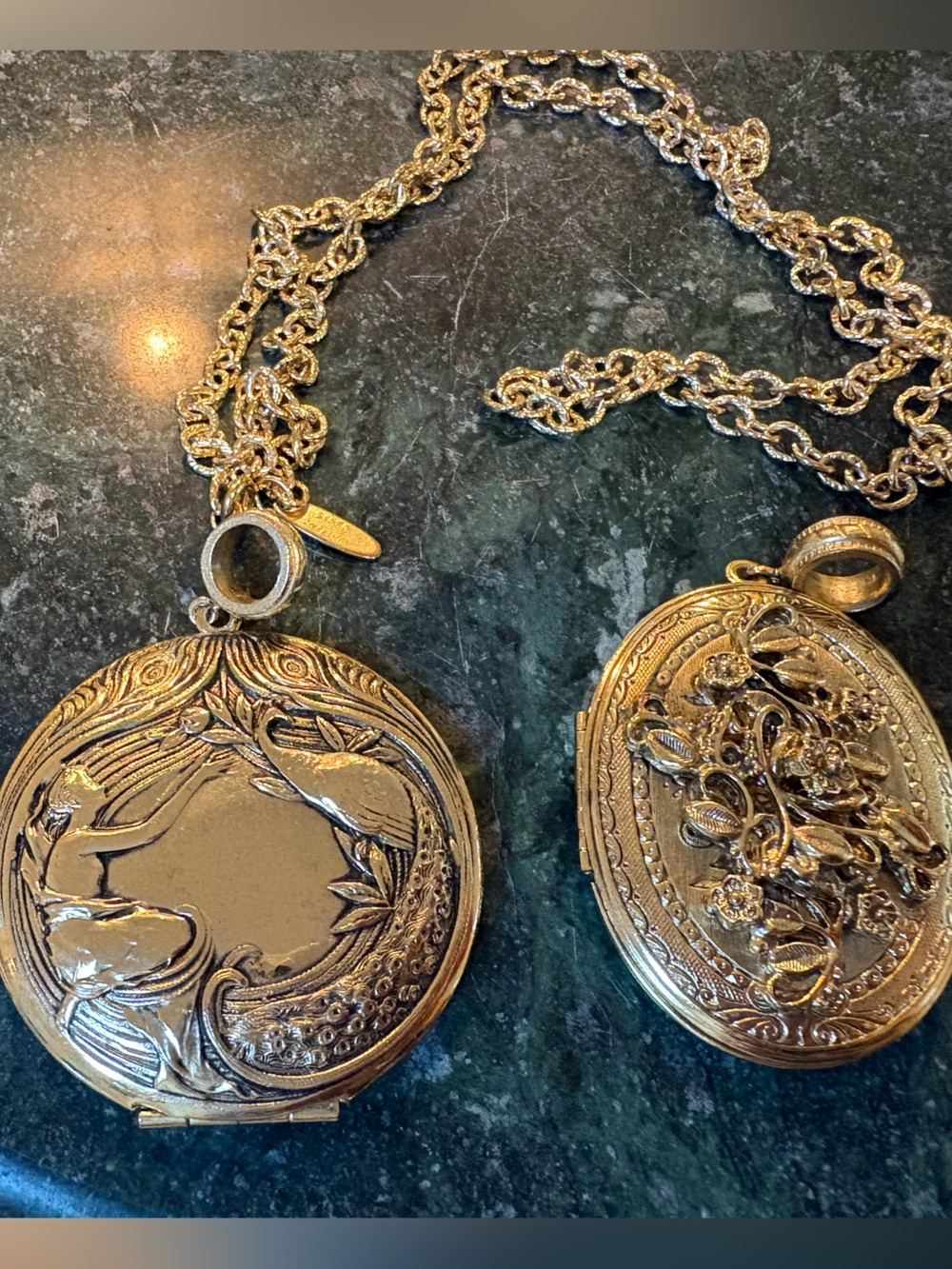 Whiting and Davis Two Gold-Tone Lockets. One Round and One Oval. One 28” Chain.